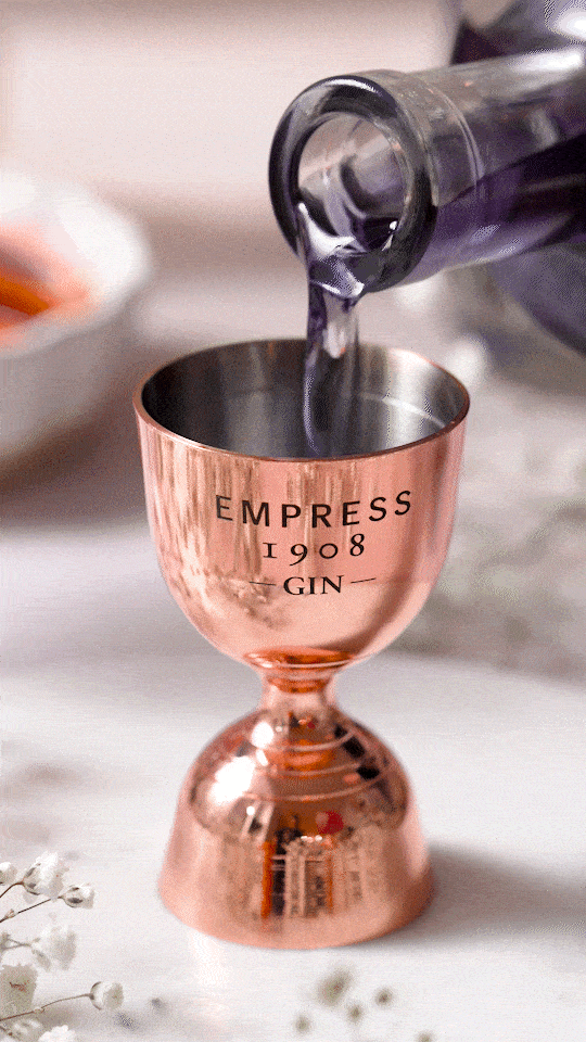 Pouring empress gin into Empress 1908 gin shot pourer.