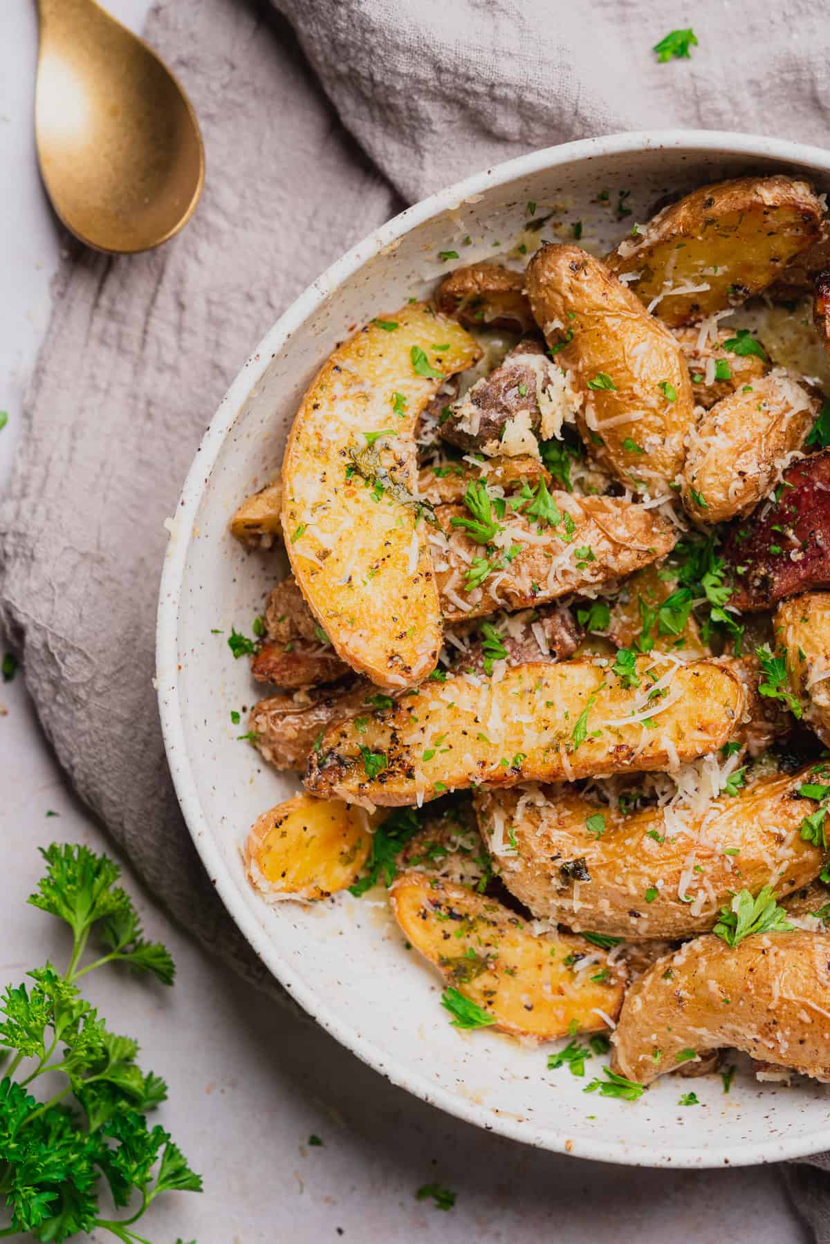 air fryer fingerling potatoes with fresh parsley, butter, and parmesan cheese 