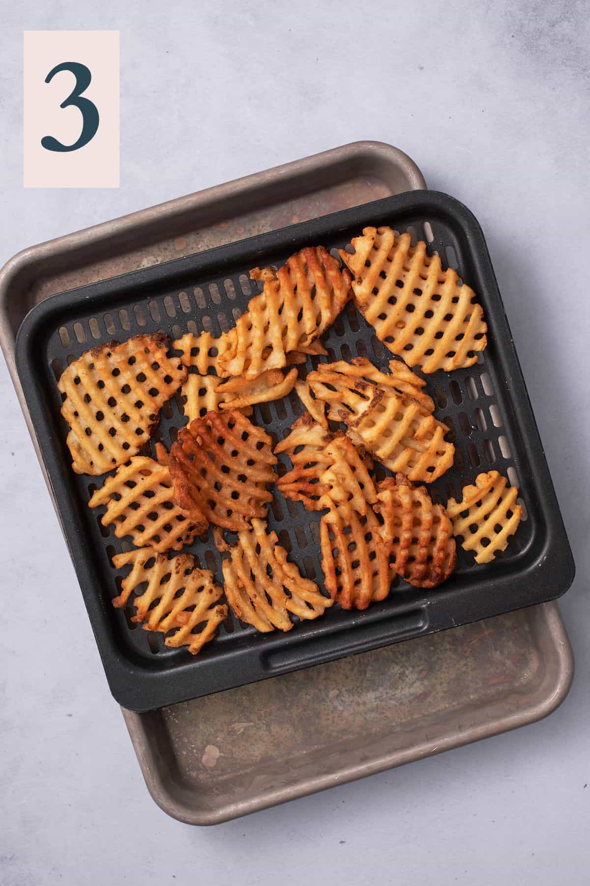 Fully cooked waffle fries that are golden brown.