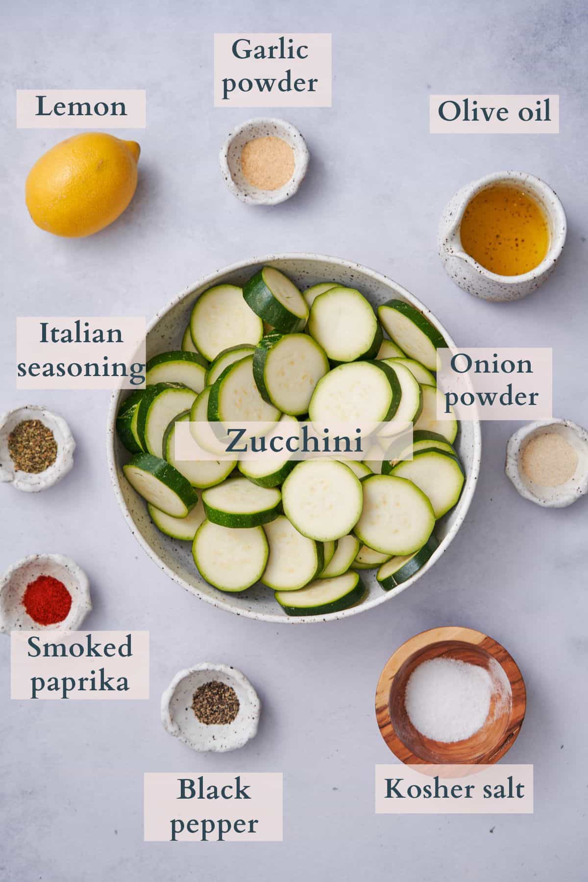 Ingredients for air fryer zucchini laid out in various bowls.