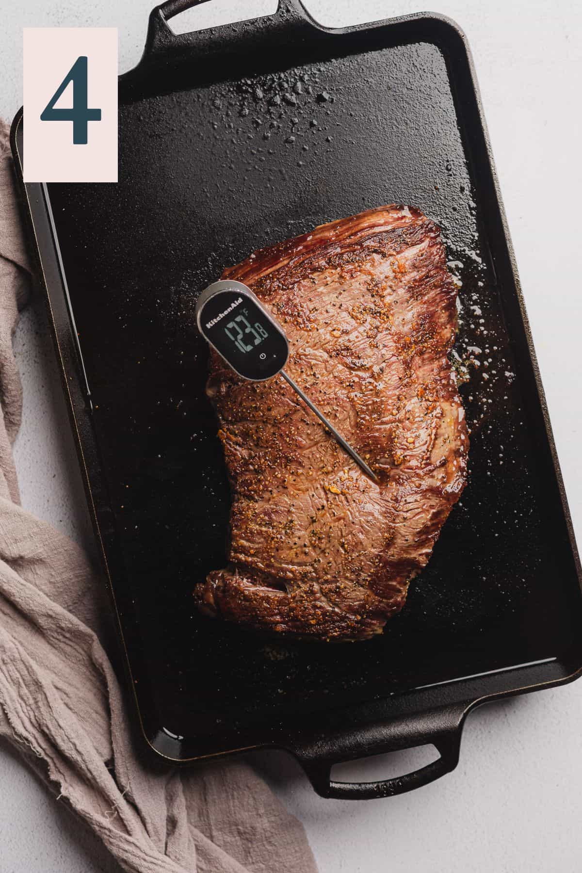 bavette steak on a grill pan cooked with a meat thermometer inside.