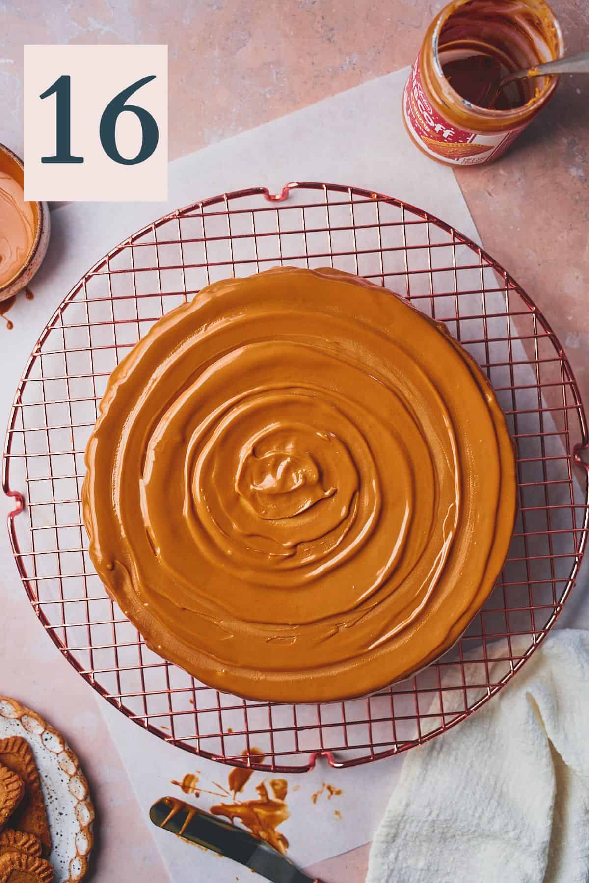 cheesecake with melted Biscoff cookie butter on top of the cheesecake in a swirl pattern on a cooling rack. 