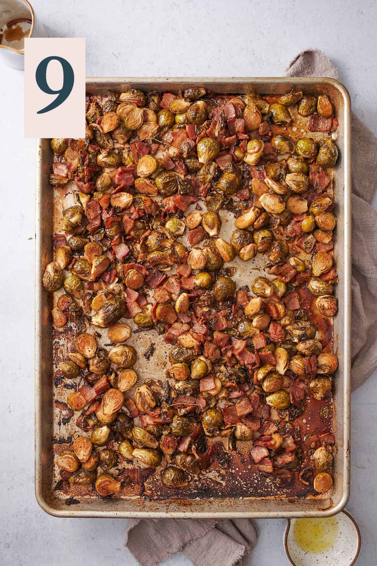 crispy roasted brussels sprouts with bacon on a baking sheet. 