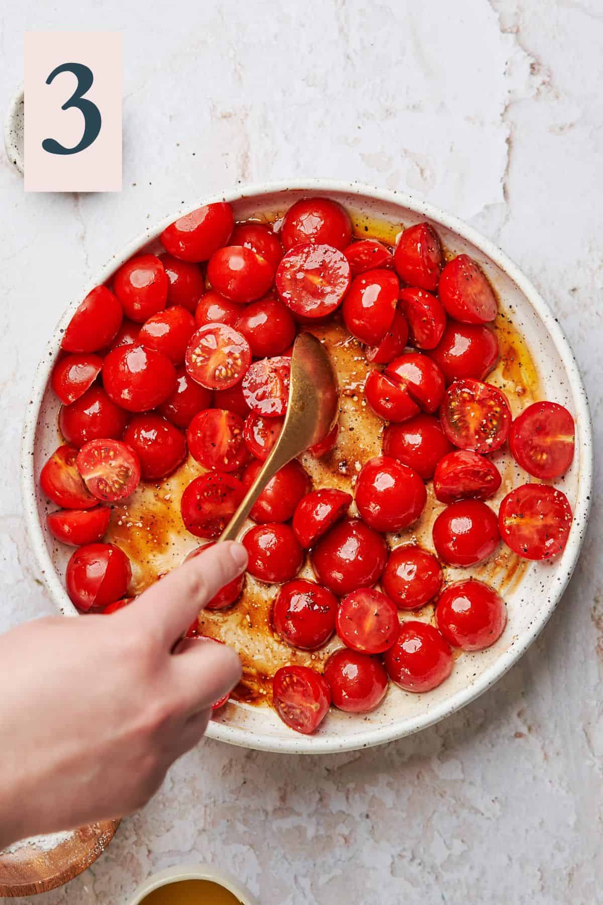 Cherry tomatoes topped with olive oil and tossed to coat evenly.