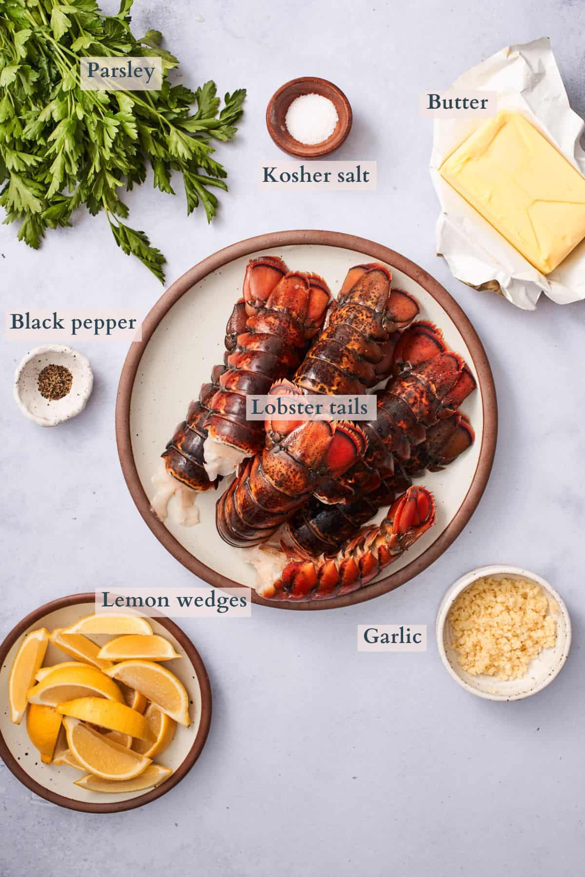 ingredients to make butter poached lobster tails with text overlaying to denote each ingredient. 