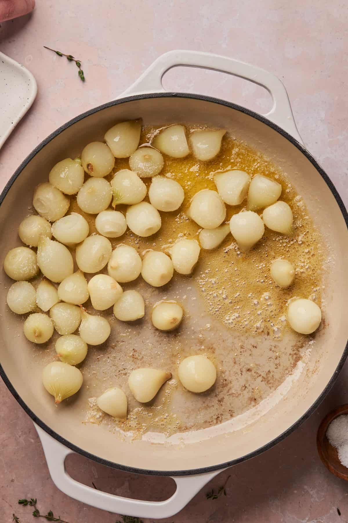 fresh pearl onions in an enameled skillet with butter.