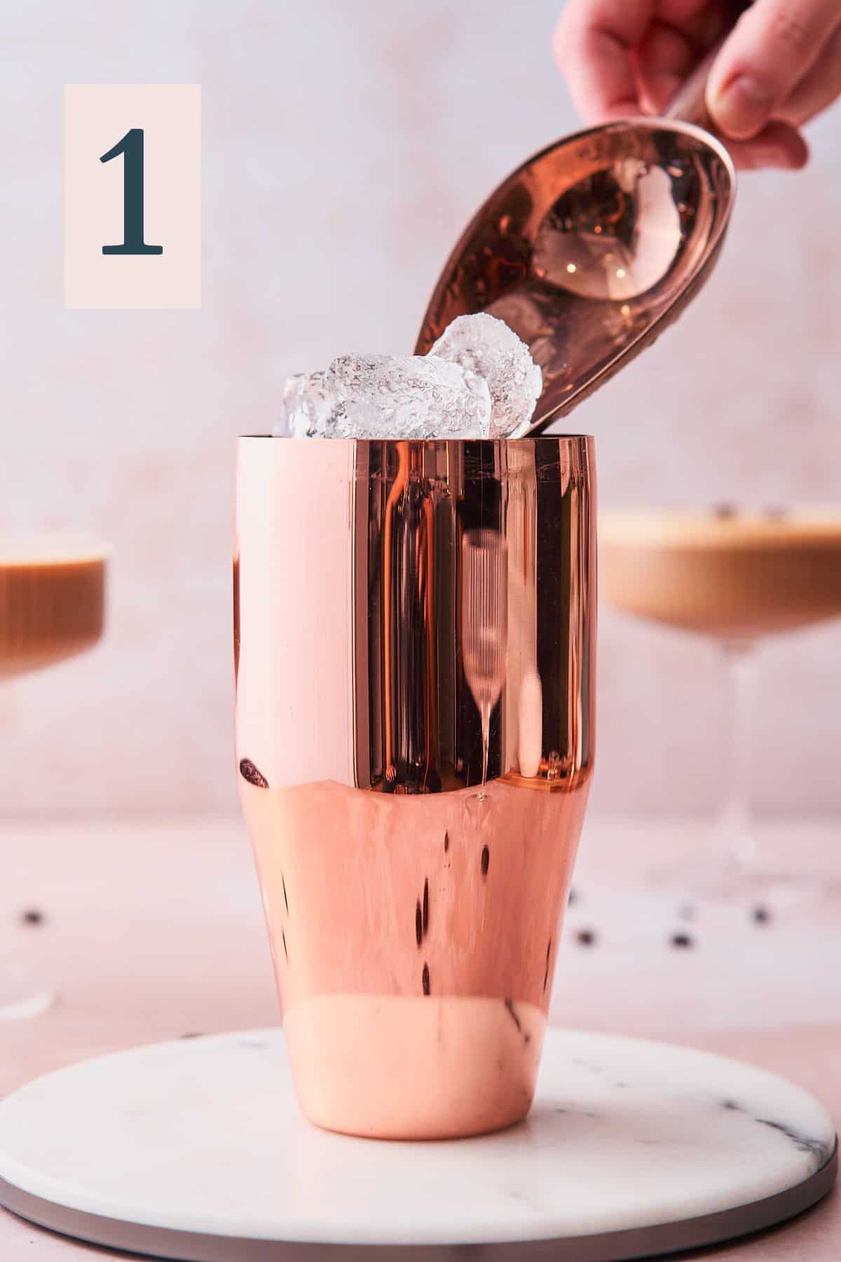 adding ice with an ice scoop to a rose gold cocktail shaker with espresso martinis in the background. 