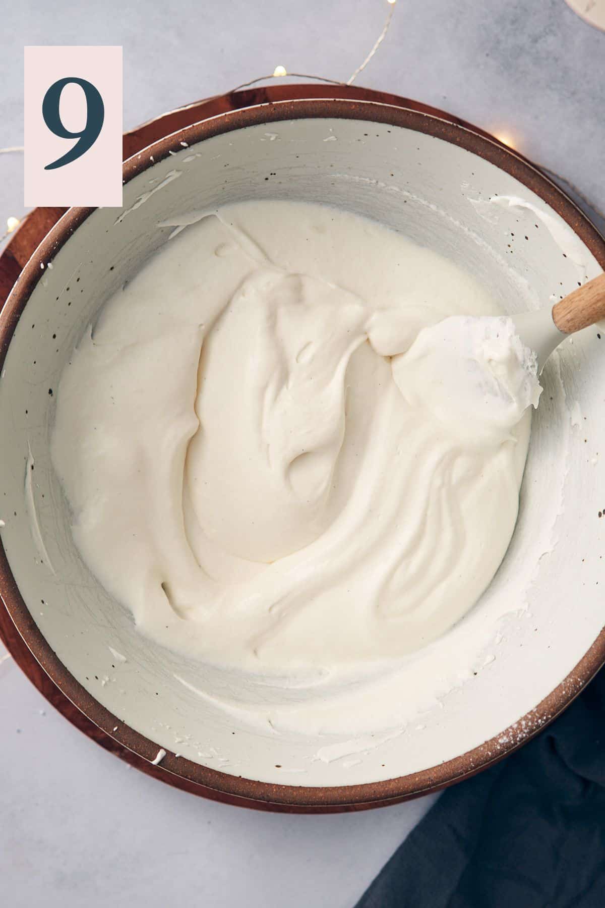 fresh made whipped cream in a large mixing bowl.