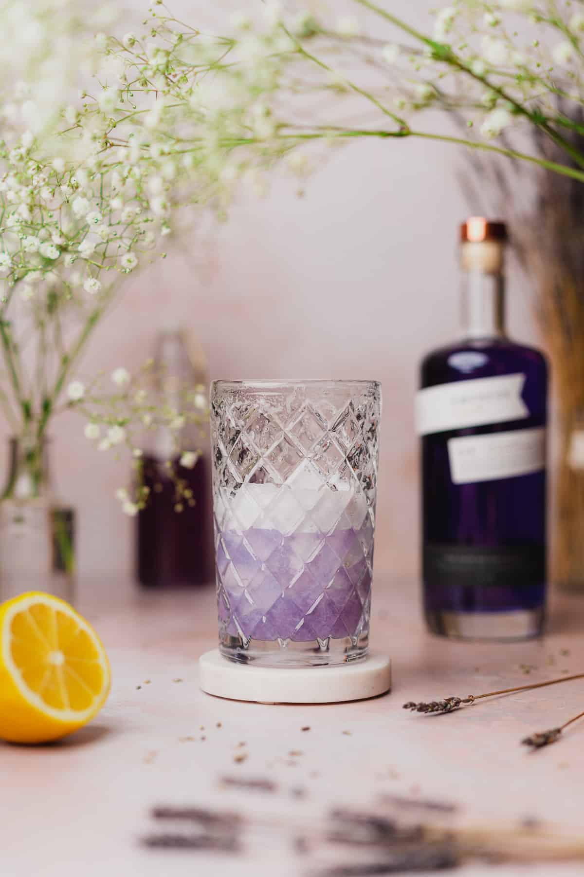 foamy lavender gin cocktail in a cocktail shaker