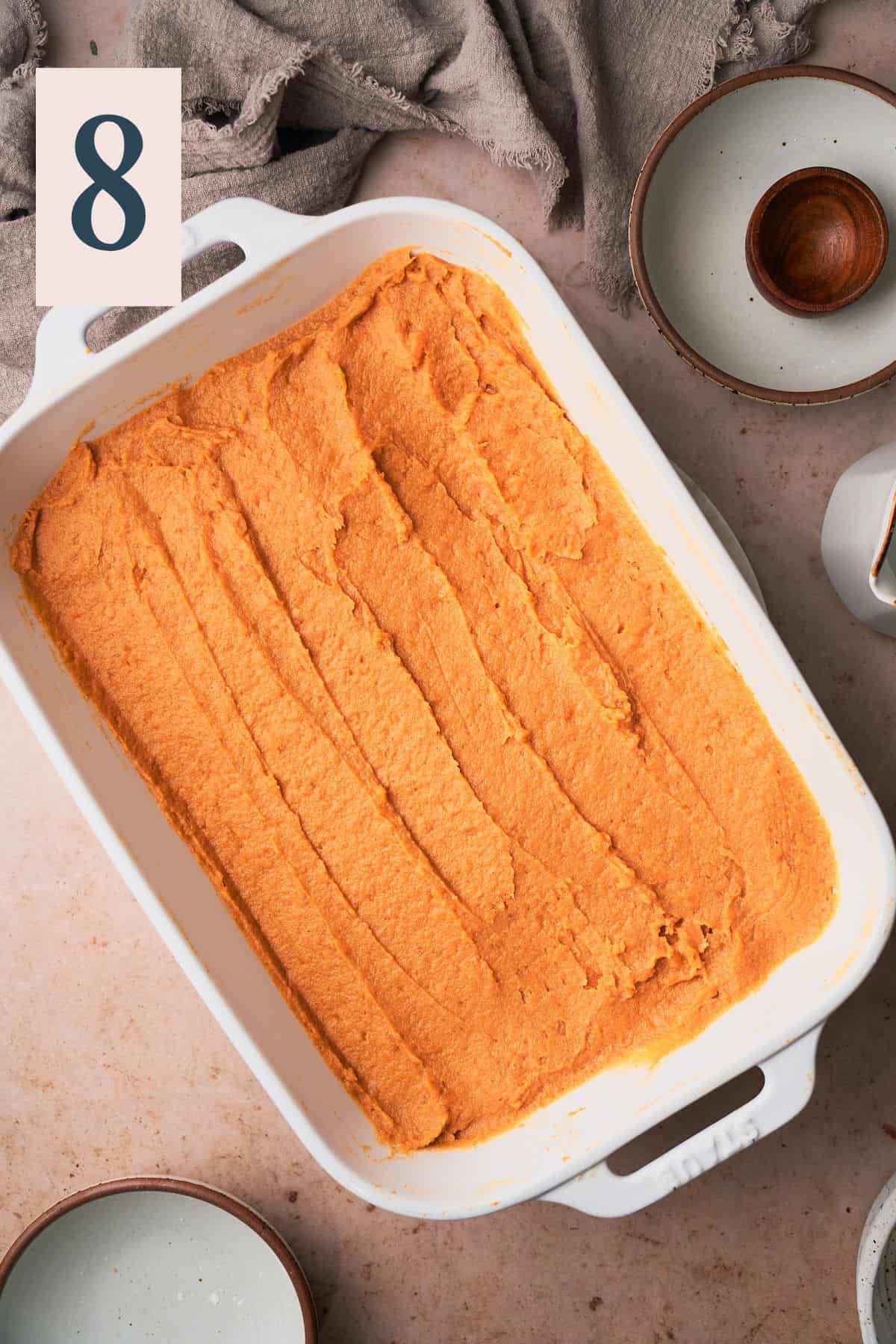 silky smooth sweet potato mixture in a square baking dish. 