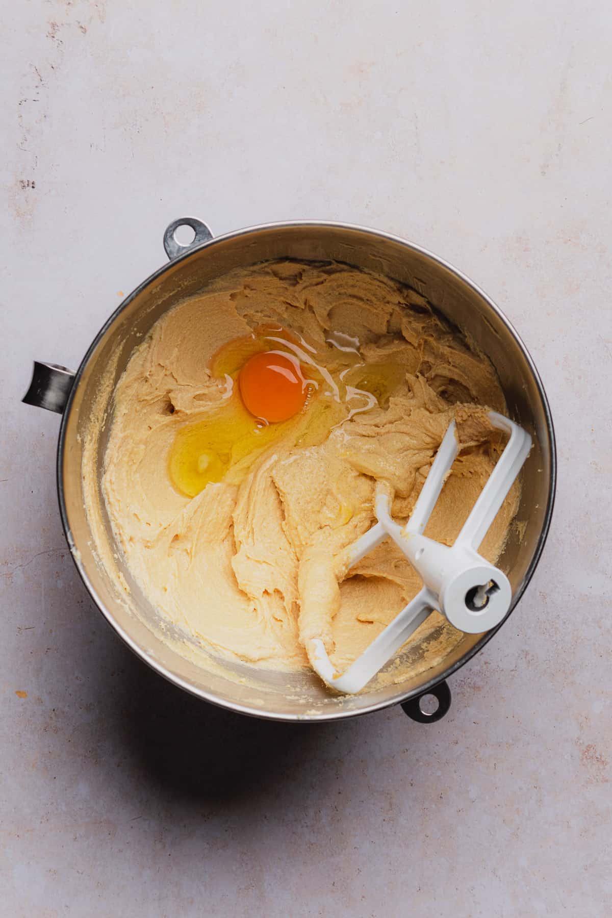 creamed wet ingredients in a bowl with an egg yolk