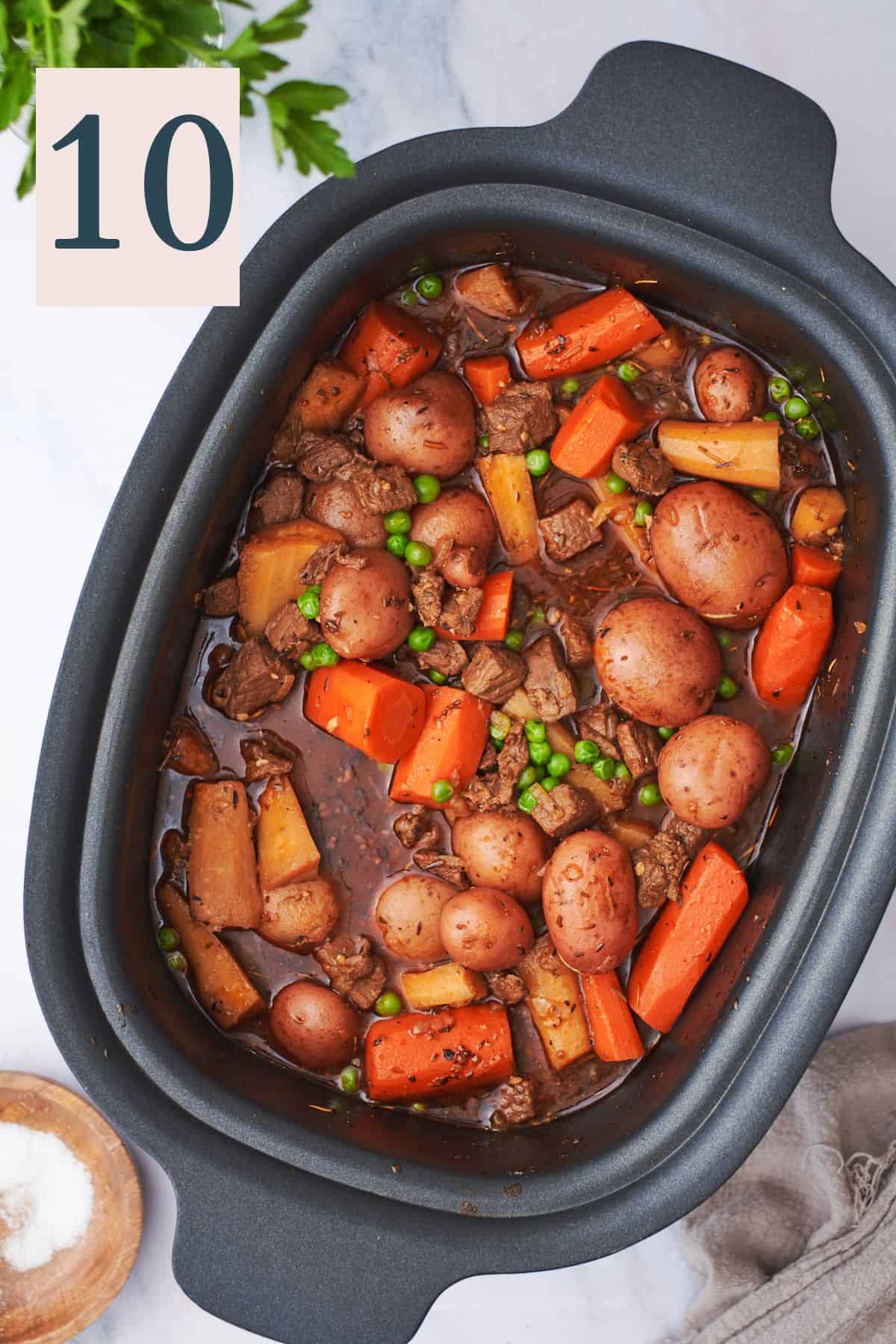 hearty beef stew with potatoes, carrots, parsnips, and peas in a slow cooker.