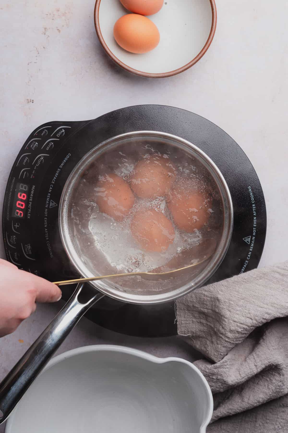 remove brown eggs from hot water in a saucepan with a slotted spoon