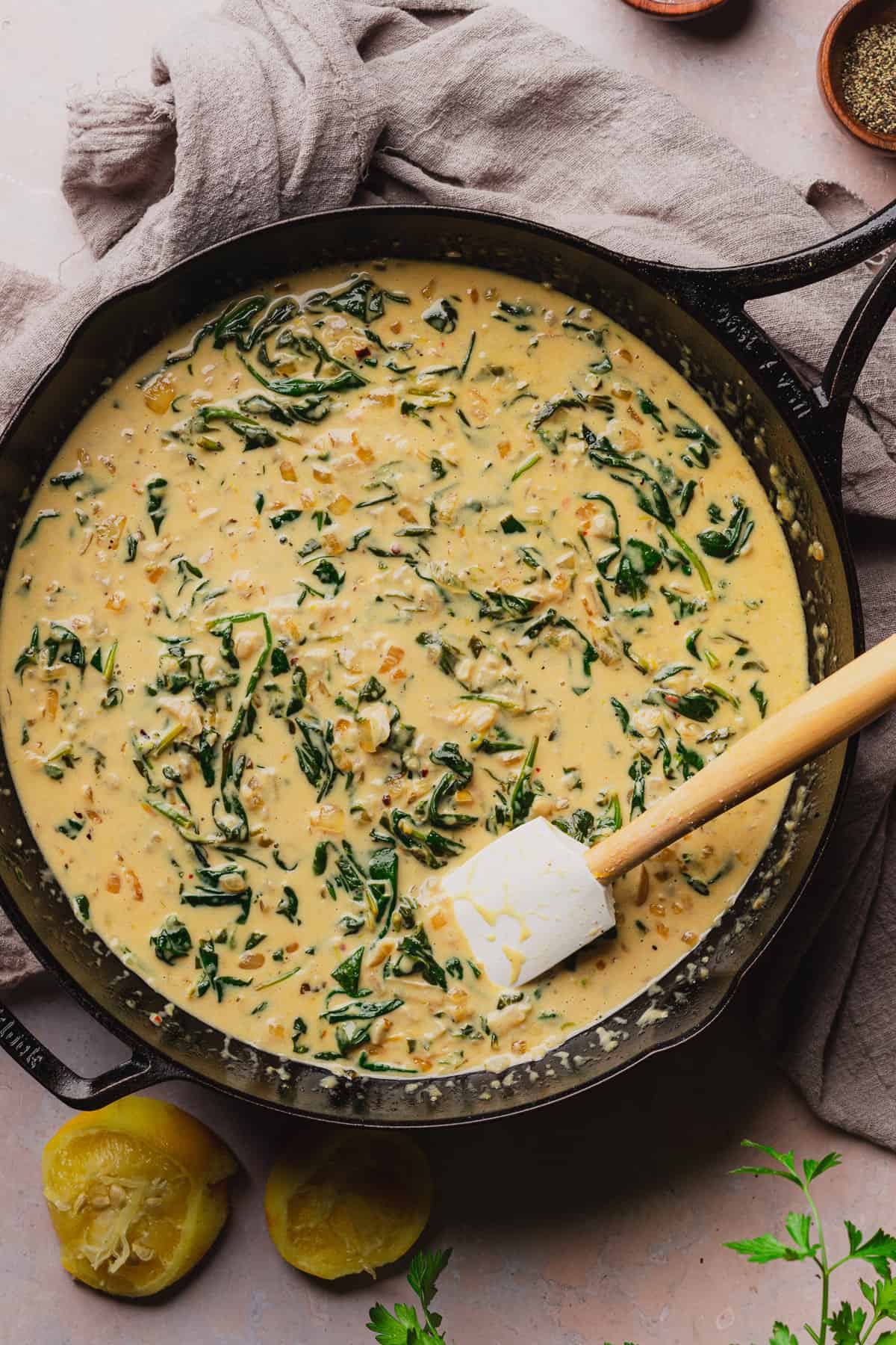 creamy garlic parmesan cream sauce with spinach in a cast iron skillet. 