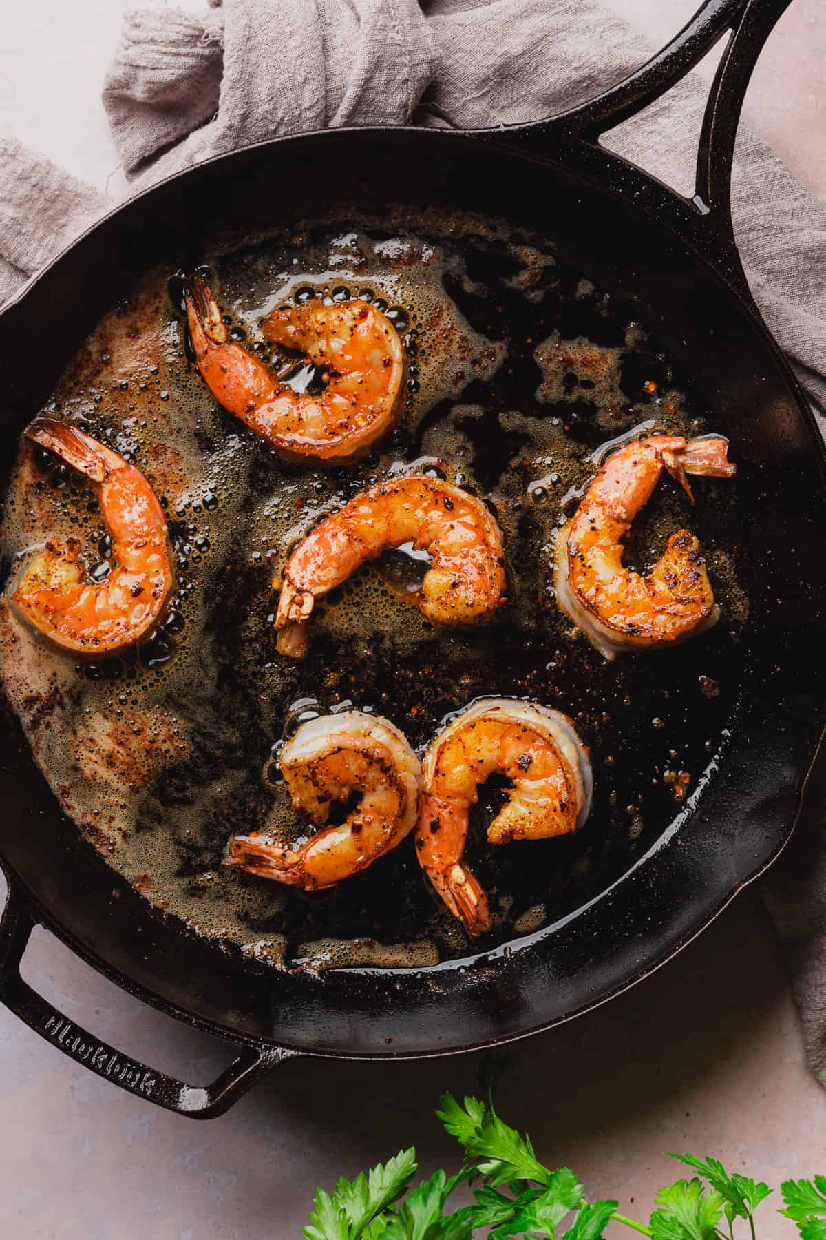 cooking shrimp in a hot cast iron skillet with butter.