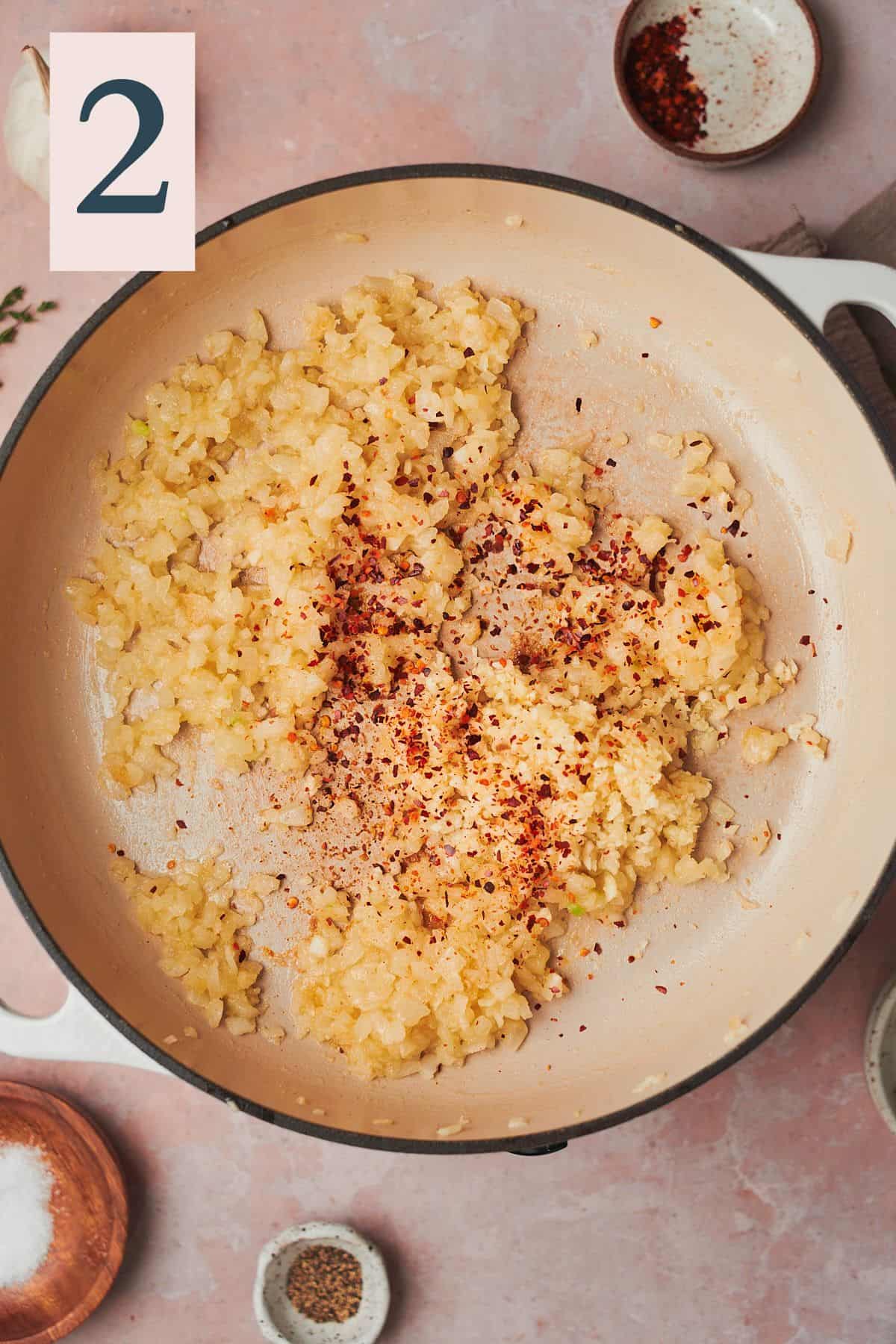 cooked onions in a skillet with garlic and red pepper flakes. 