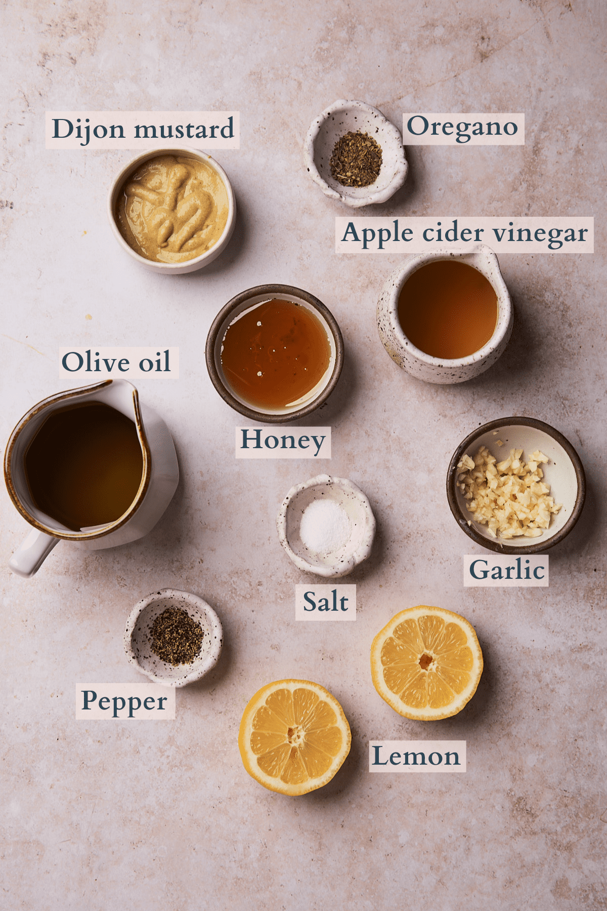 honey lemon vinaigrette dressing ingredients including dijon mustard, salt, pepper, oregano, olive oil. vinegar, lemon, garlic and honey. 